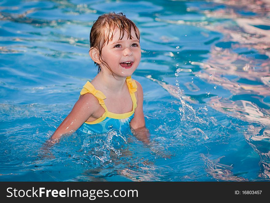 The cheerful child bathes in pool. The cheerful child bathes in pool