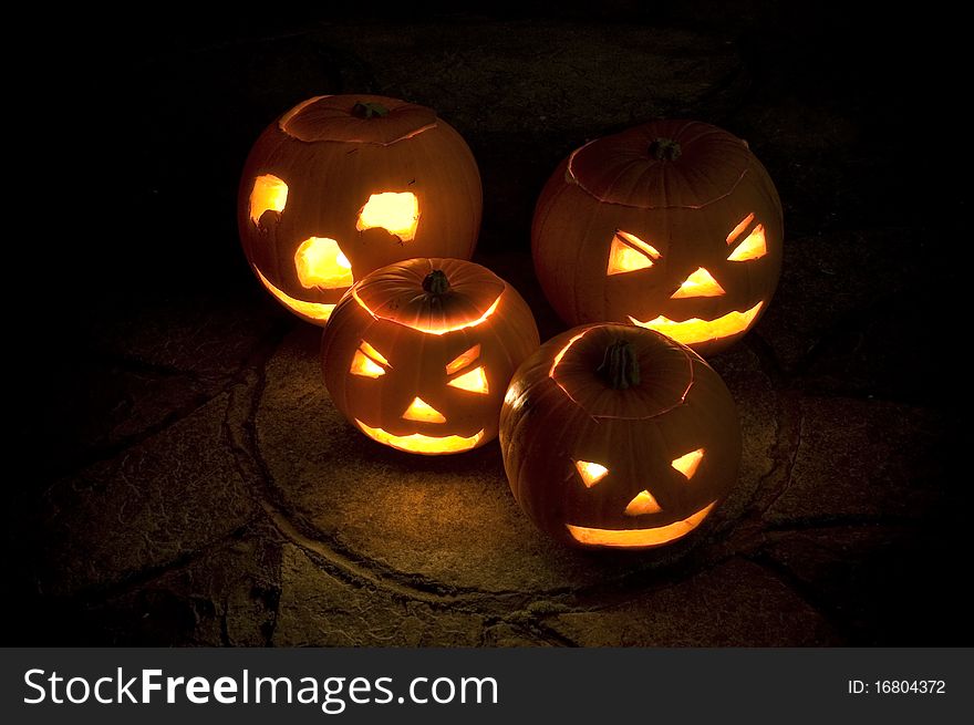 A group of Pumkins, Illuminated by candles & photographed at night. A group of Pumkins, Illuminated by candles & photographed at night
