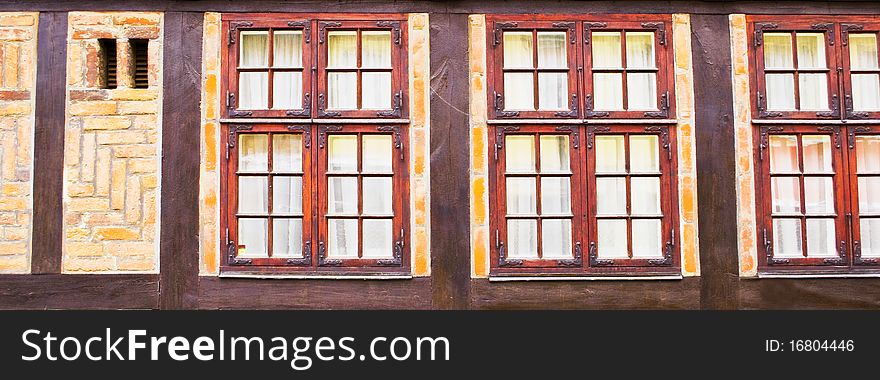 House wall with beautiful wooden vintage windows