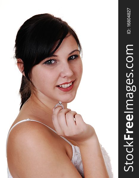 A beautiful young woman holds up her new engagement diamond ring, headshot, on white background. A beautiful young woman holds up her new engagement diamond ring, headshot, on white background.