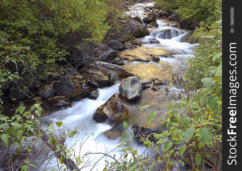 A mountain stream splashes down it's stony way.