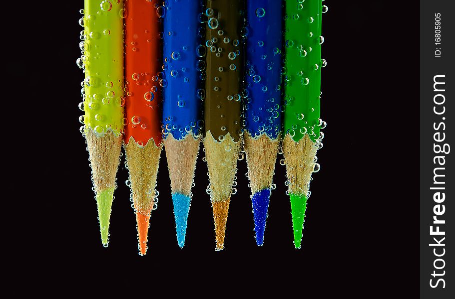 Multicolored pencils isolated on black background. Multicolored pencils isolated on black background