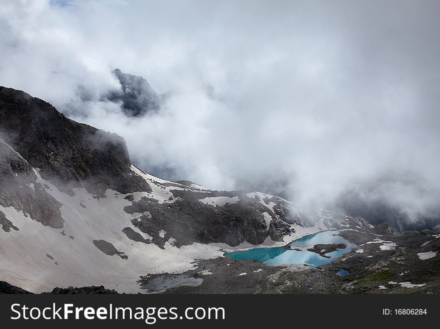 Mountain landscape with mist and blue lake. Mountain landscape with mist and blue lake