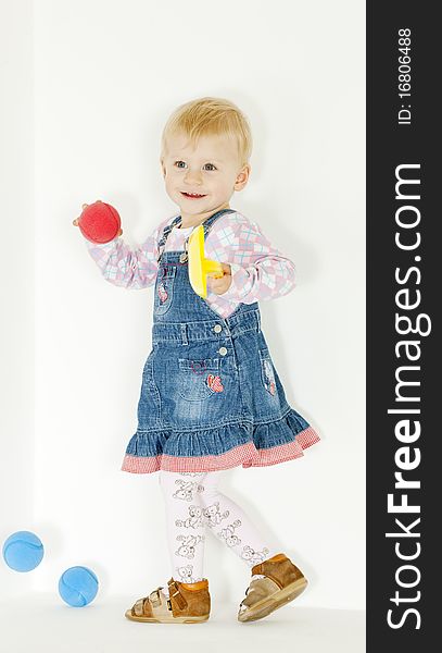 Standing toddler girl with balls
