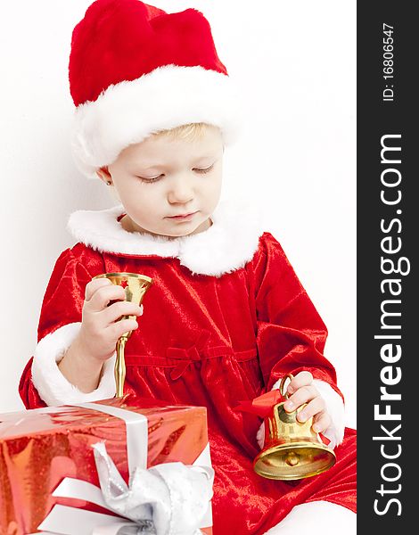 Little girl as Santa Claus with bells and Christmas present