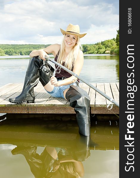 Fishing woman sitting on pier. Fishing woman sitting on pier