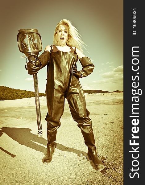 Standing woman with gas mask wearing protective clothes