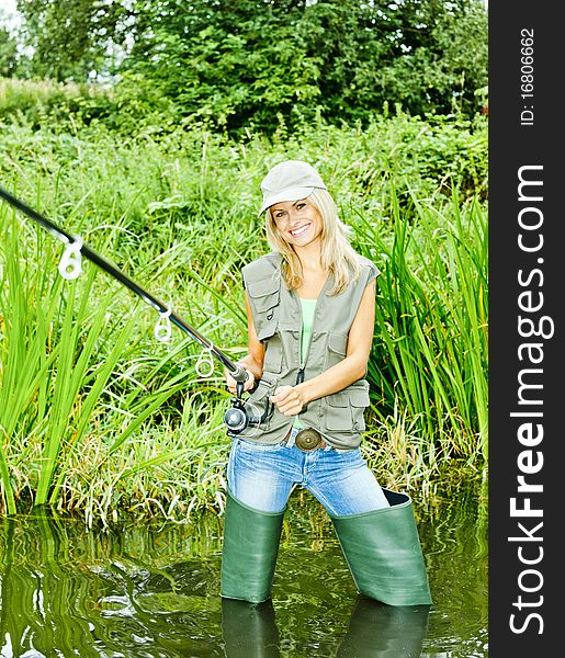 Young woman fishing in pond. Young woman fishing in pond