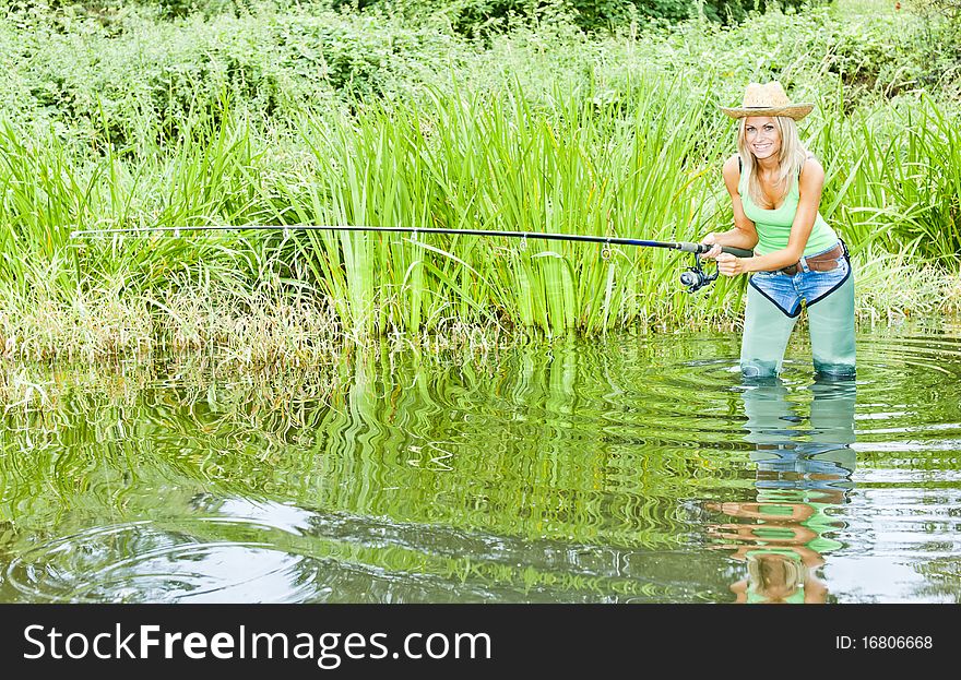 Yougn woman fishing in pond. Yougn woman fishing in pond
