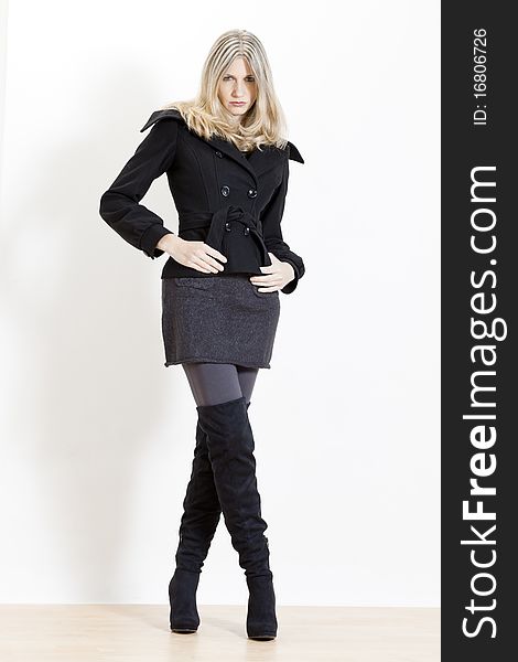 Standing woman wearing fashionable black boots