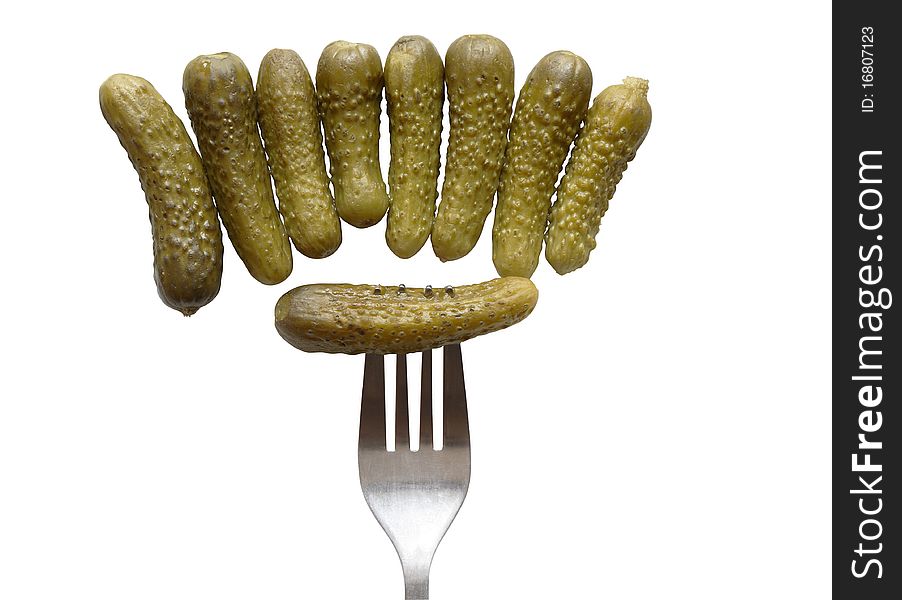 Few gherkins and one fork isolated on white background with clipping path. Few gherkins and one fork isolated on white background with clipping path