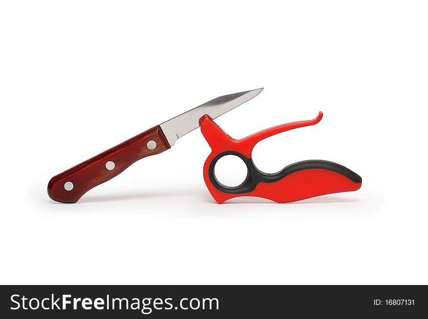 Red plastic knife sharpener and kitchen knife isolated on white background with clipping path. Red plastic knife sharpener and kitchen knife isolated on white background with clipping path