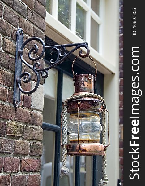 A brass lantern hanging outside a house in Edam. A brass lantern hanging outside a house in Edam.