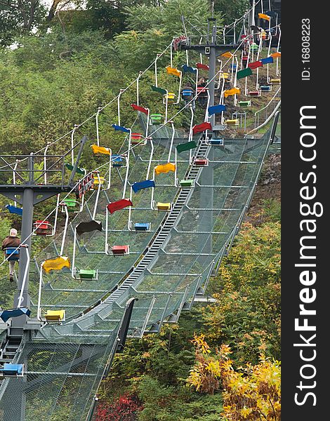 Funicular railway with varicoloured easy chair in zoo of the Prague