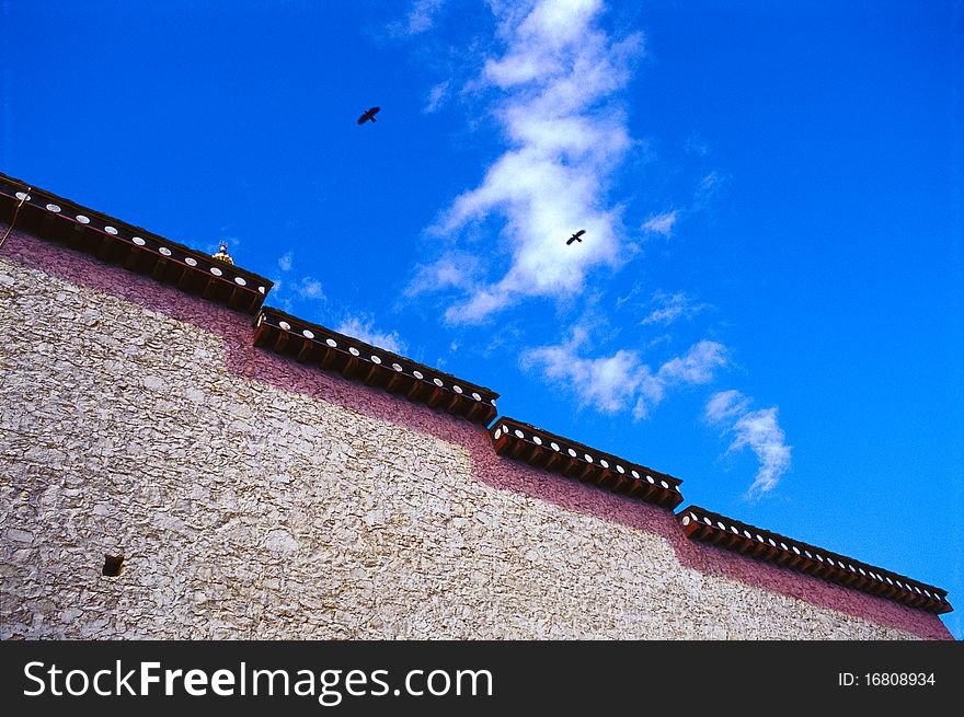 There is a lama temple in Shangri-La under blue sky.