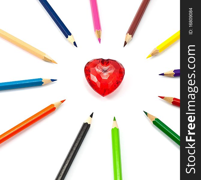 Red crystal heart surrounded with color pencil. Red crystal heart surrounded with color pencil