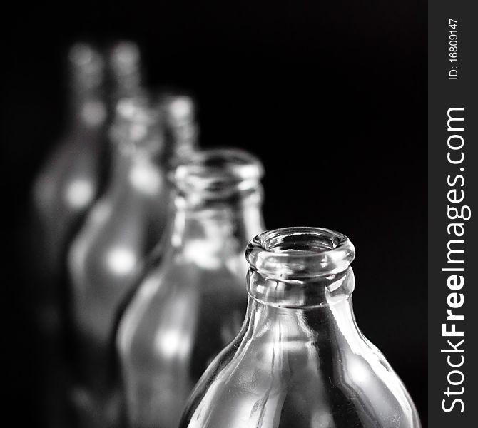 Empty bottles collection, colorless, isolated on black background