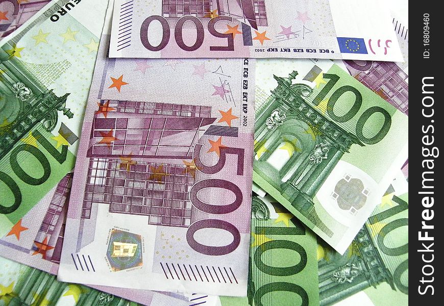 Background of scattered 100 and 500 euro banknotes