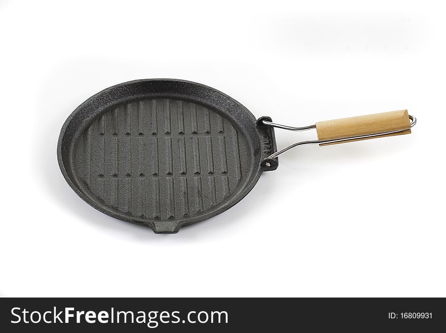 On a white background round grill pan with a wooden handle. On a white background round grill pan with a wooden handle.