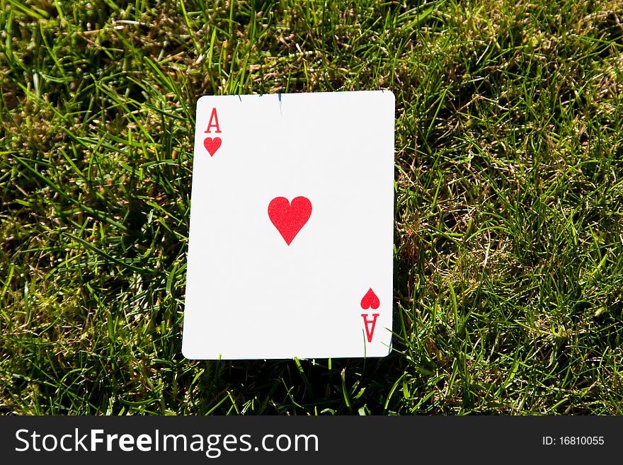 The ace of hearts on grass