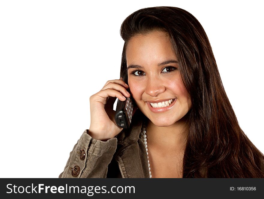 A young hispanic female talking on a telephone. She has a beautiful smile, long brown hair and young, fresh face. A young hispanic female talking on a telephone. She has a beautiful smile, long brown hair and young, fresh face.