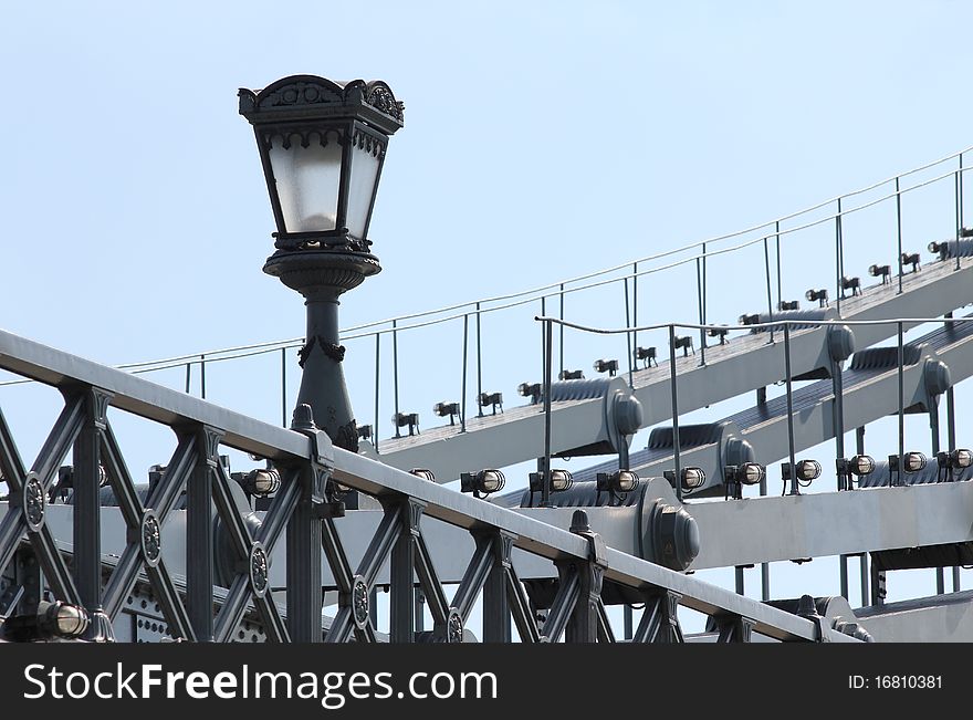 Lamp and old iron bridge structure.