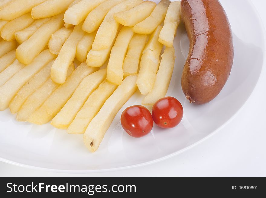 Sausage with a fried potato in a plate.