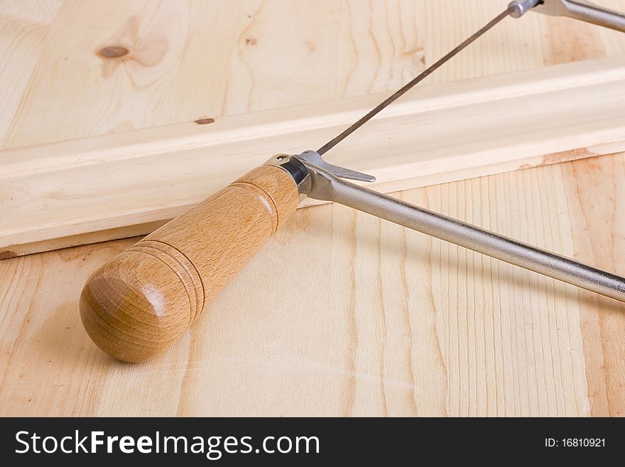 Coping saw on a piece of wood. Coping saw on a piece of wood.