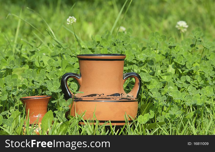 Brown vases with a grass background