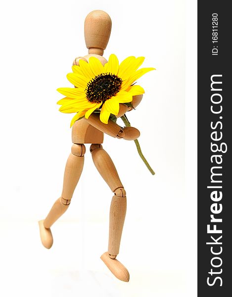 Wood figure with sunflower in arms over white background