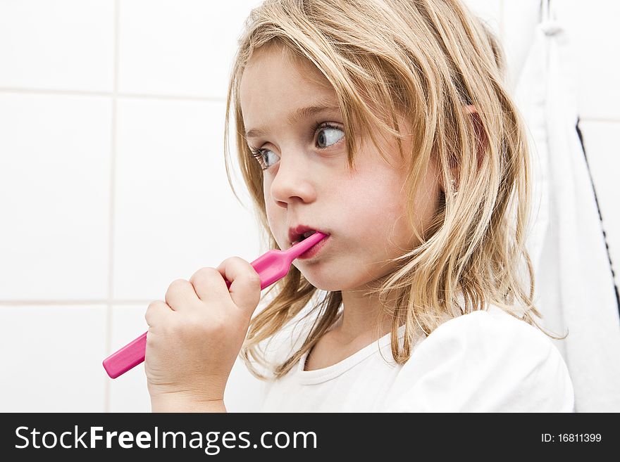 Little girl with toothbrush in the bathroom. Little girl with toothbrush in the bathroom