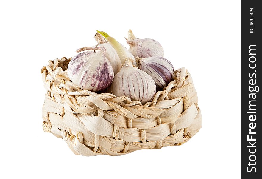 Garlic heads in a small wattled box, a basket. Garlic heads in a small wattled box, a basket