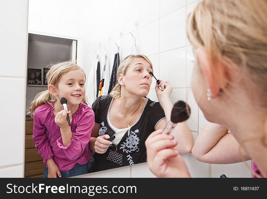 Mother and Daughter put on make-up