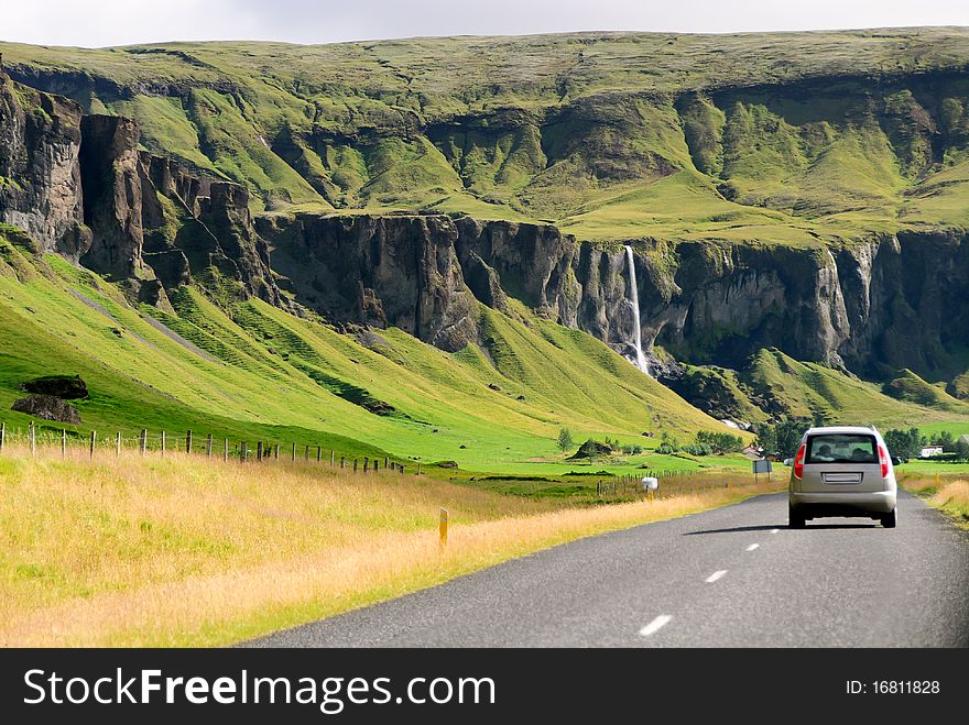 Road with a waterfall in southern Iceland. Road with a waterfall in southern Iceland