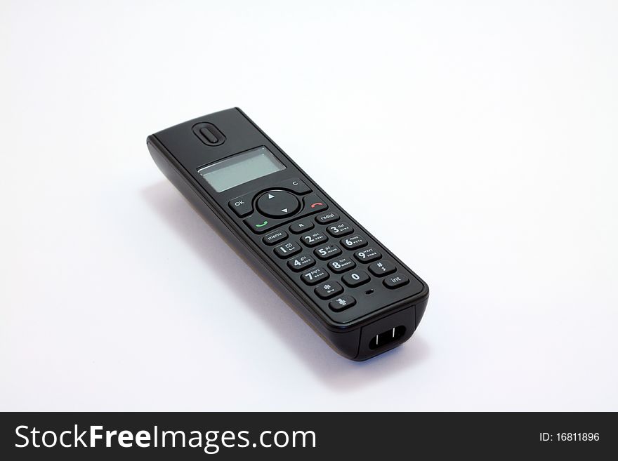 Modern digital black cordless phone at the white background. Modern digital black cordless phone at the white background