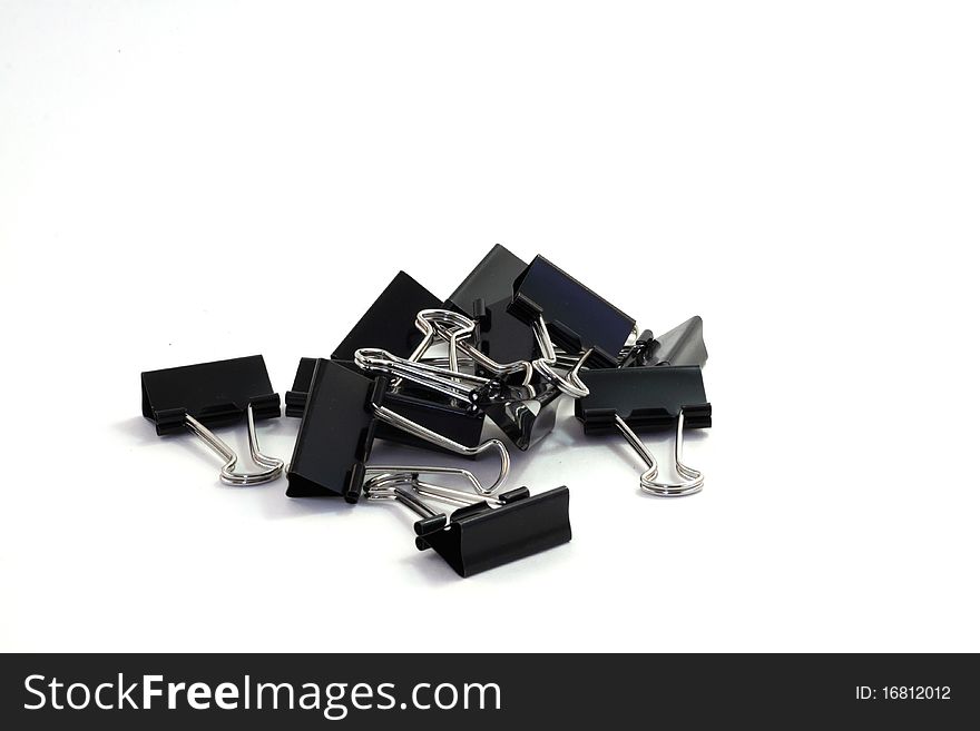 Pile of binder clips on a white background. Pile of binder clips on a white background