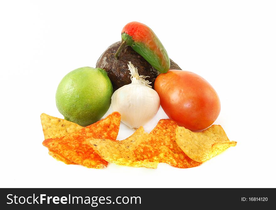 Ingredients for making guacamole dip on top of nacho chips. Ingredients for making guacamole dip on top of nacho chips