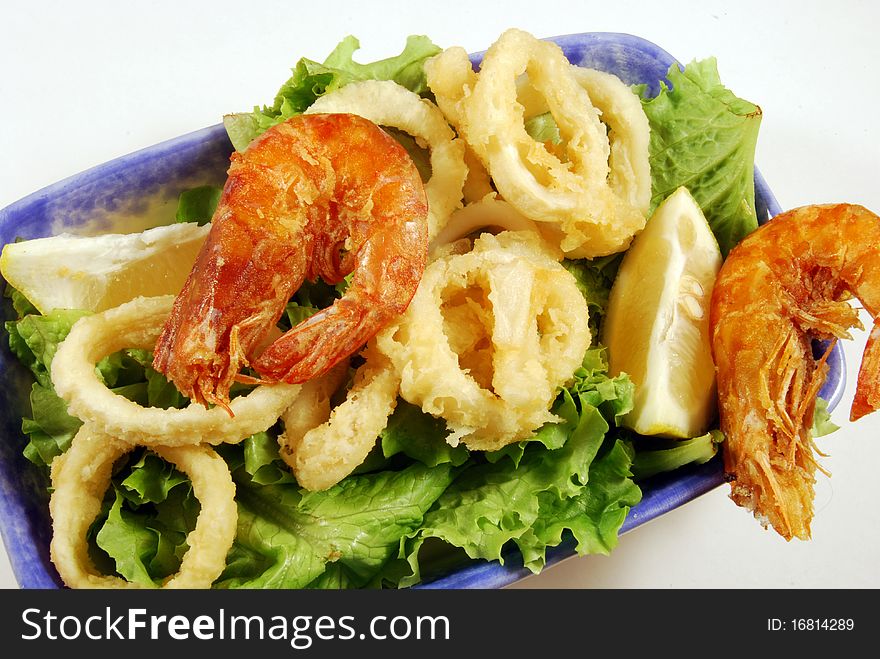 Fried calamari rings and shrimp nestled on a bed of lettuce