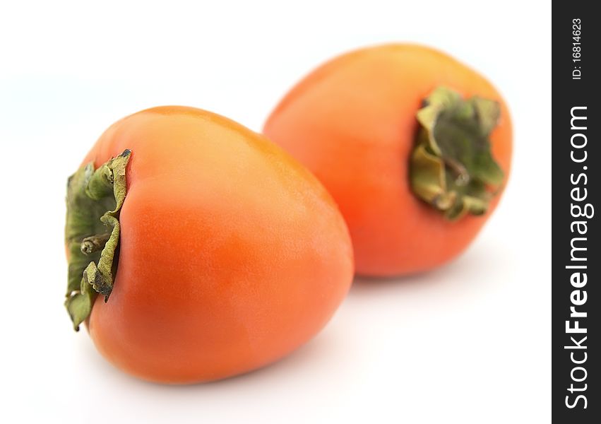 Ripe persimmon closeup on a white background