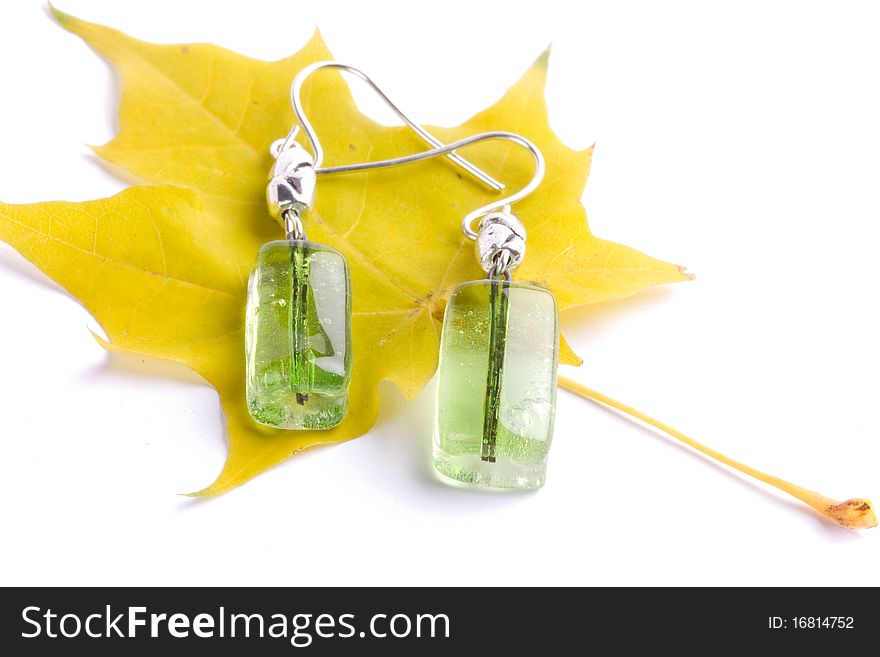 Glass earring together with maple leaf. Glass earring together with maple leaf