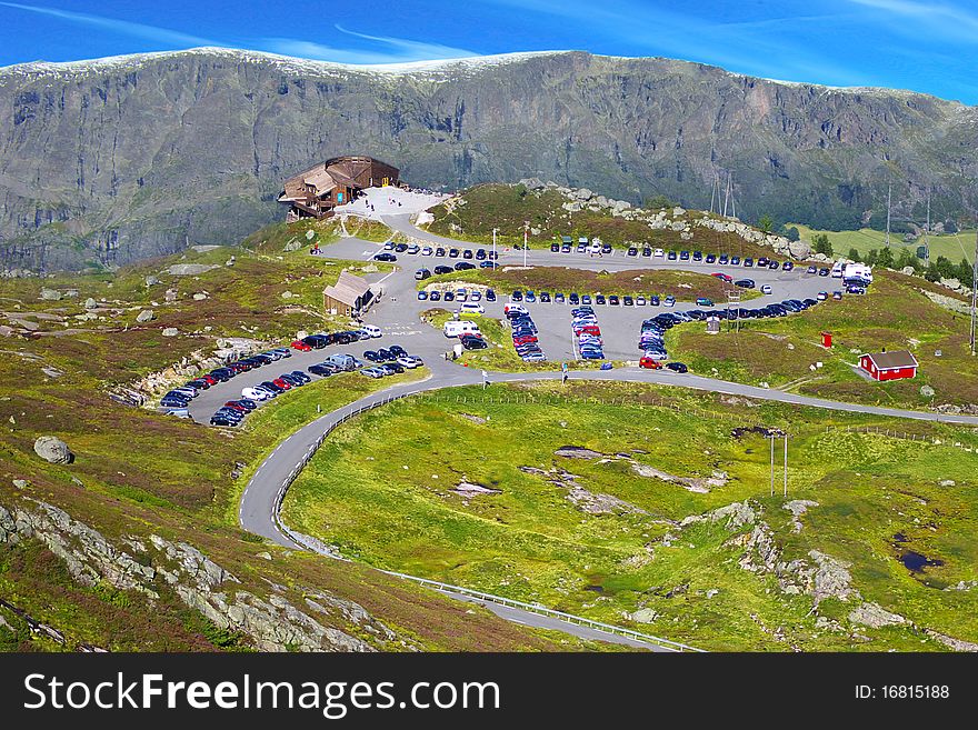 On the photo: Picturesque Norway mountain landscape with parking.