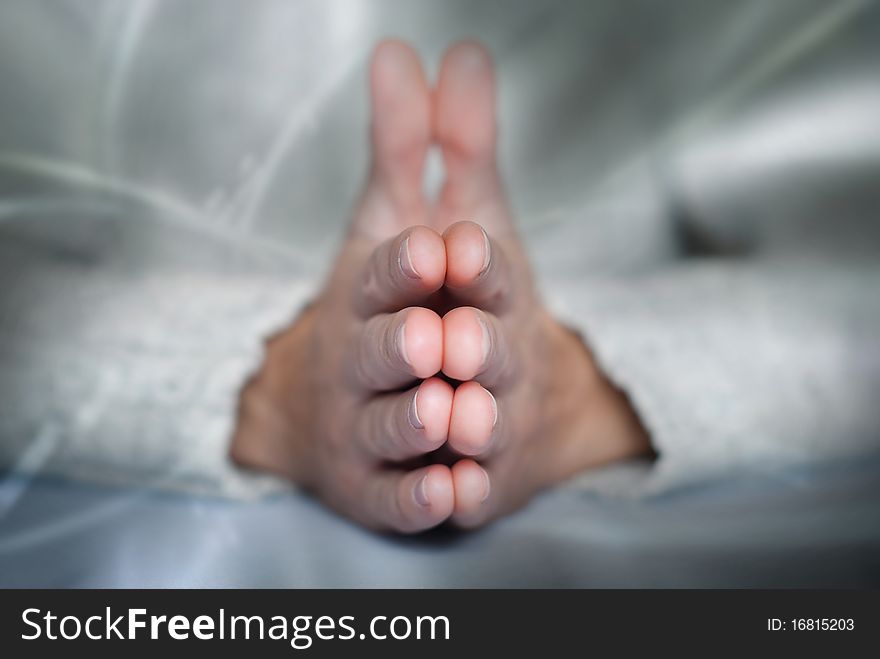 Young man's palms in calm position at abstract background