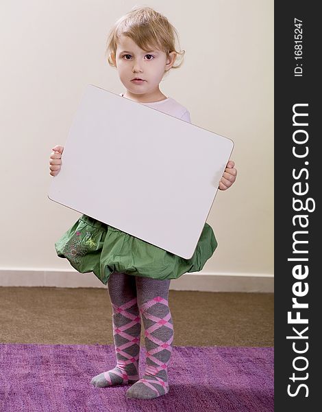 3-years old girl holding a white board