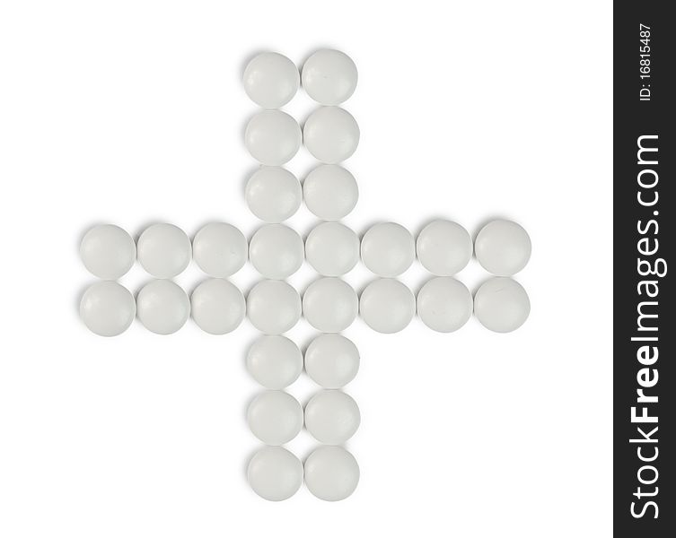 Cross-shaped group of pills isolated on white