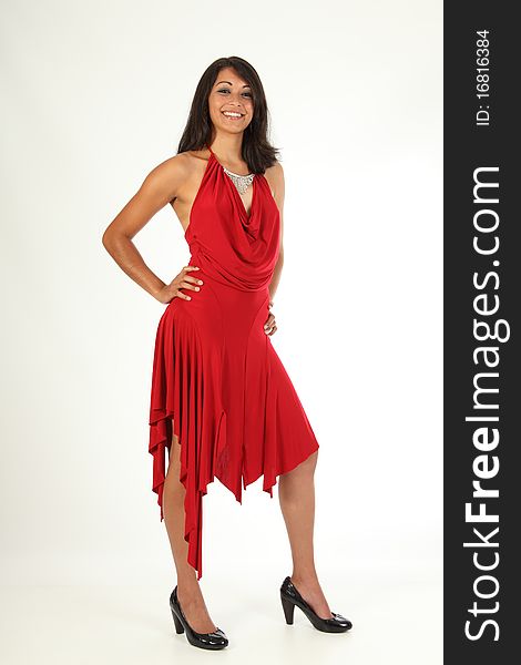 Happy smile from beautiful young woman wearing a red dress. This is a full length body shot. Happy smile from beautiful young woman wearing a red dress. This is a full length body shot.