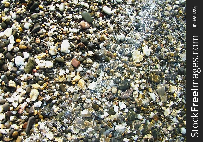 Background.Pebble On A Beach In Sea Water