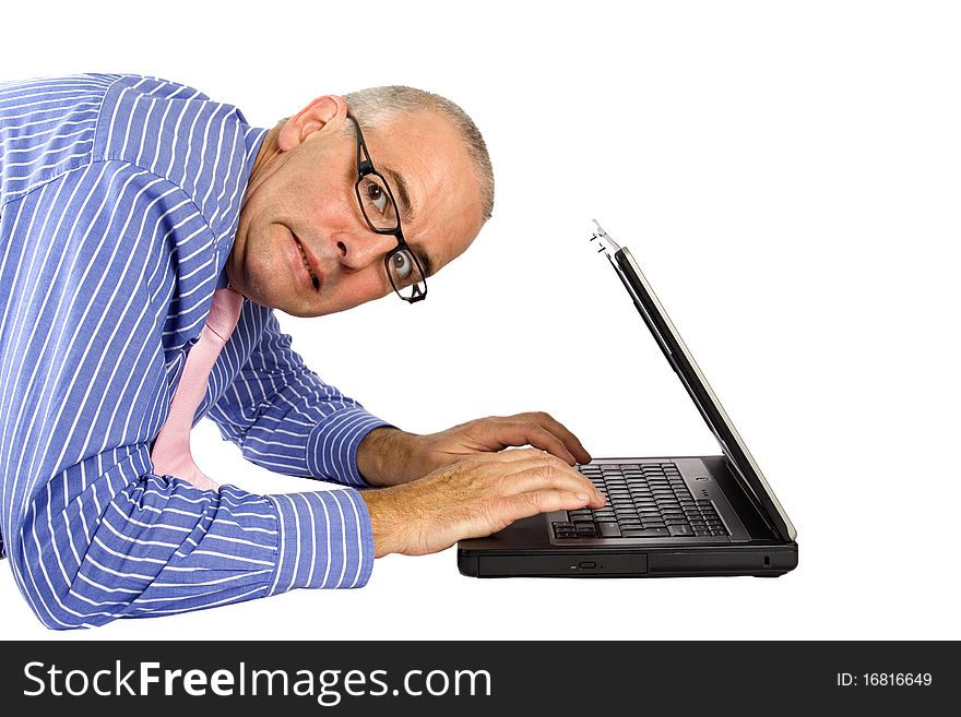 Man in shirt and tie using a laptop with a stressed look. Man in shirt and tie using a laptop with a stressed look.