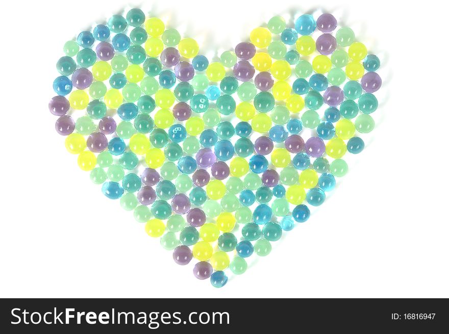 Water absorbent colorful balls , heart background. Water absorbent colorful balls , heart background