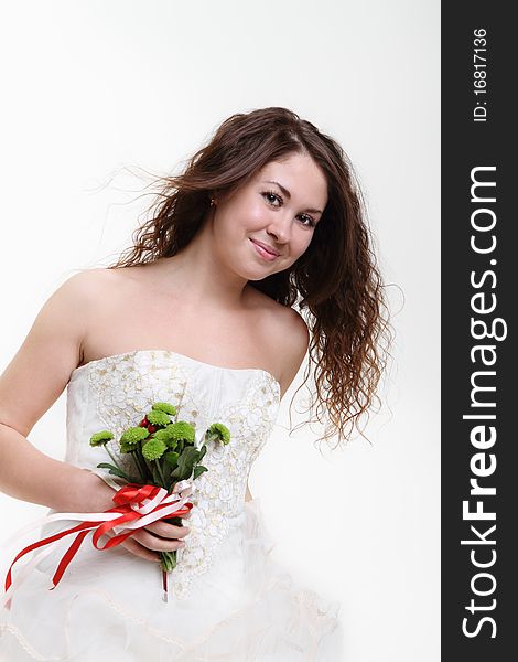 Portrait of the smiling girl with bouquet