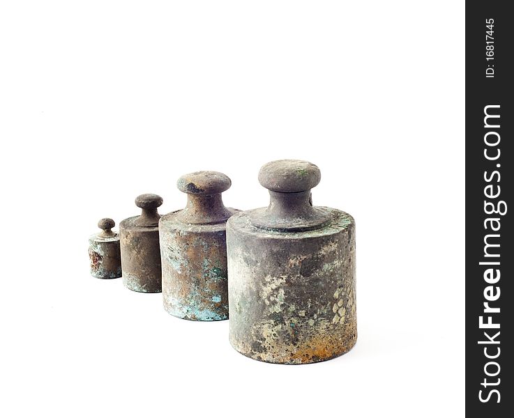 Four ancient metal weights on white background. Four ancient metal weights on white background